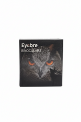A black rectangular box for Eycbre Binoculars featuring a printed owl face with bright orange eyes on the front, photographed against a plain white background.