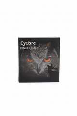 A black rectangular box for Eycbre Binoculars featuring a printed owl face with bright orange eyes on the front, photographed against a plain white background.