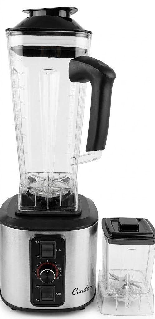 A countertop blender with a clear pitcher, black lid and handle, and a brushed silver base, shown alongside a small clear container with a black lid on a white background.
