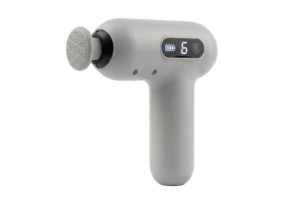 A modern gray handheld massage gun with a digital display showing battery level and mode number 6, set against a plain white background.